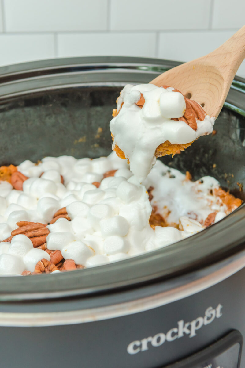 cooked sweet potatoes on a wooden spoon