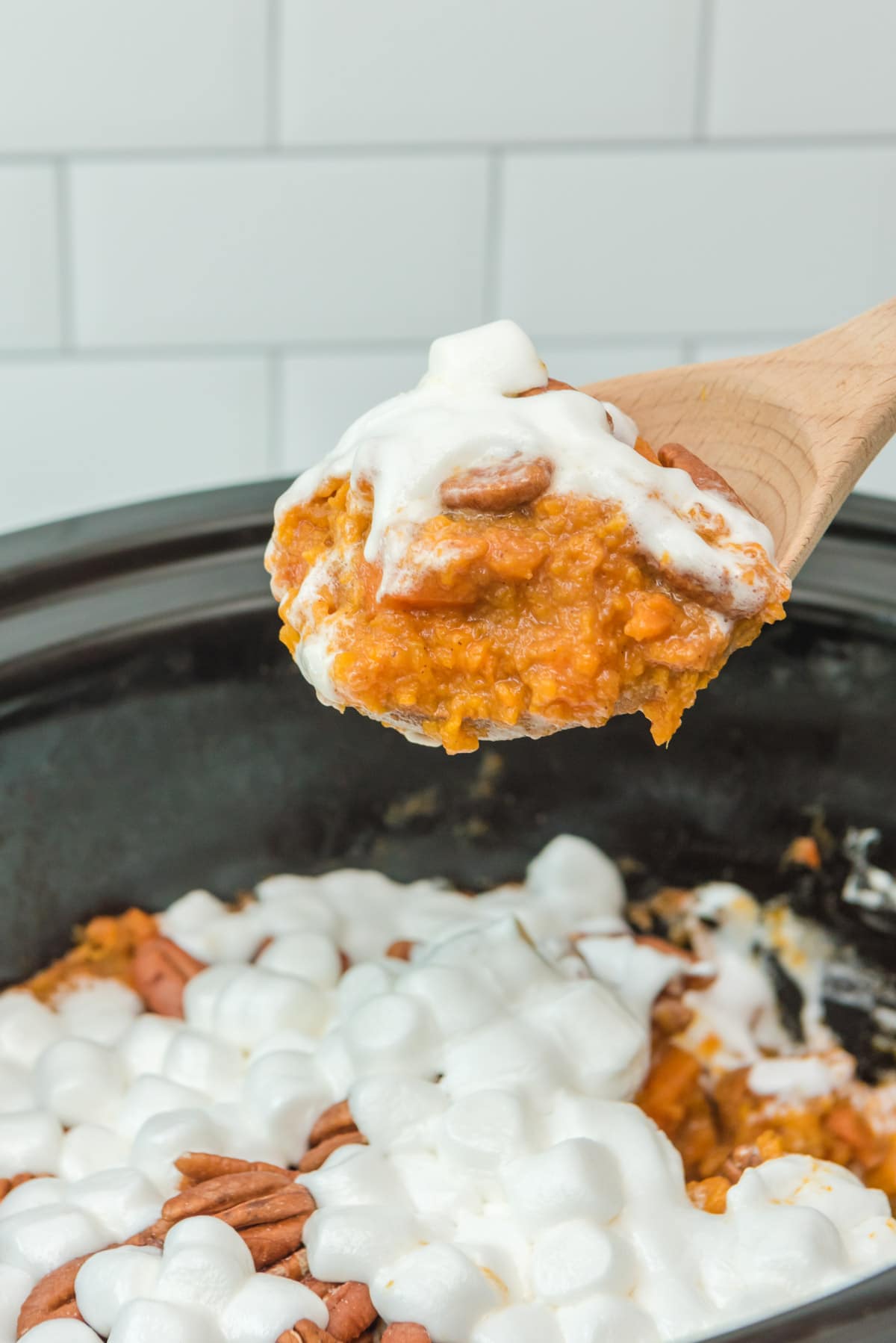 sweet potato casserole with marshmallows on a spoon