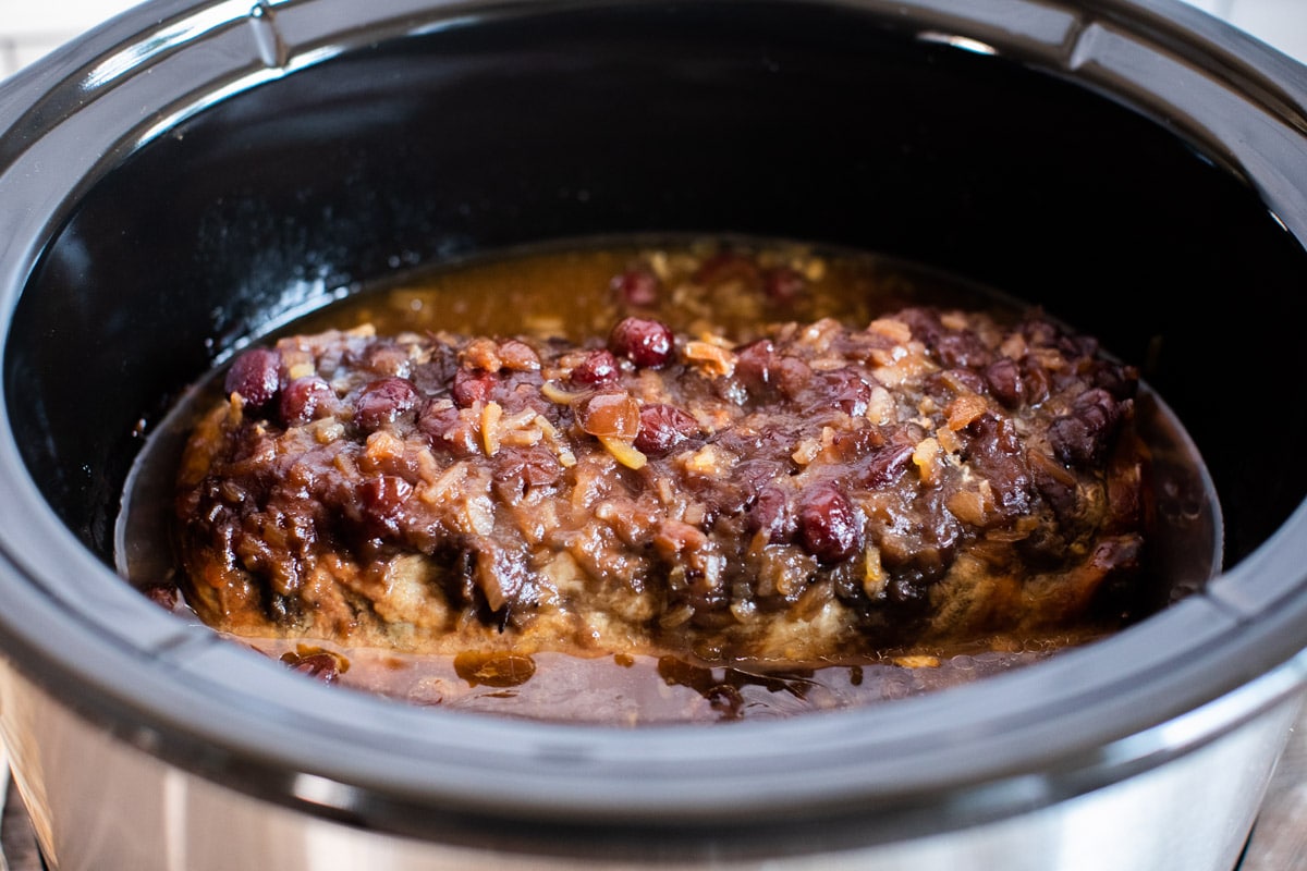 side view of cranberry pork loin in slow cooker
