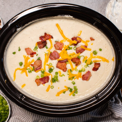 baked potato soup topped with cheese, bacon and green onions