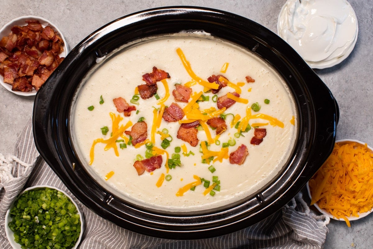 baked potato soup topped with cheese, bacon and green onions