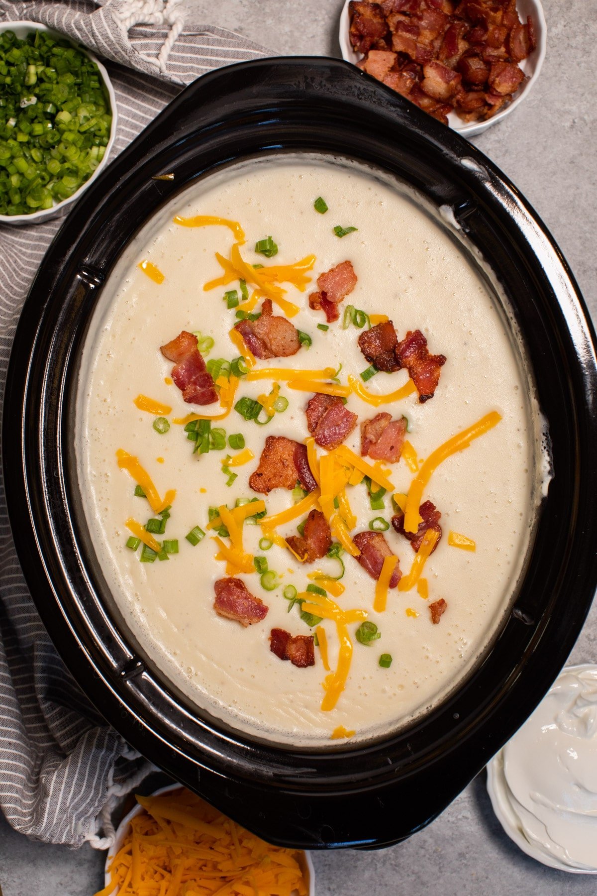 Close up of baked potato soup in slow cooker