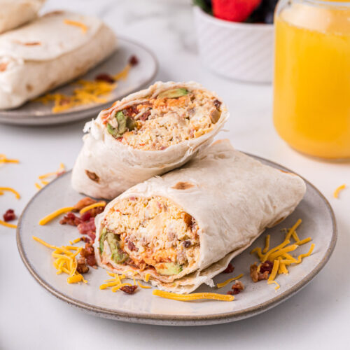 breakfast burritos sliced in half on plate