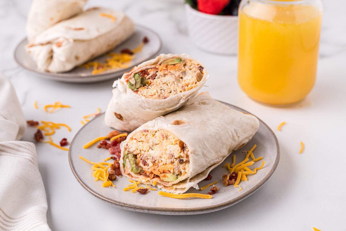 breakfast burritos sliced in half on plate