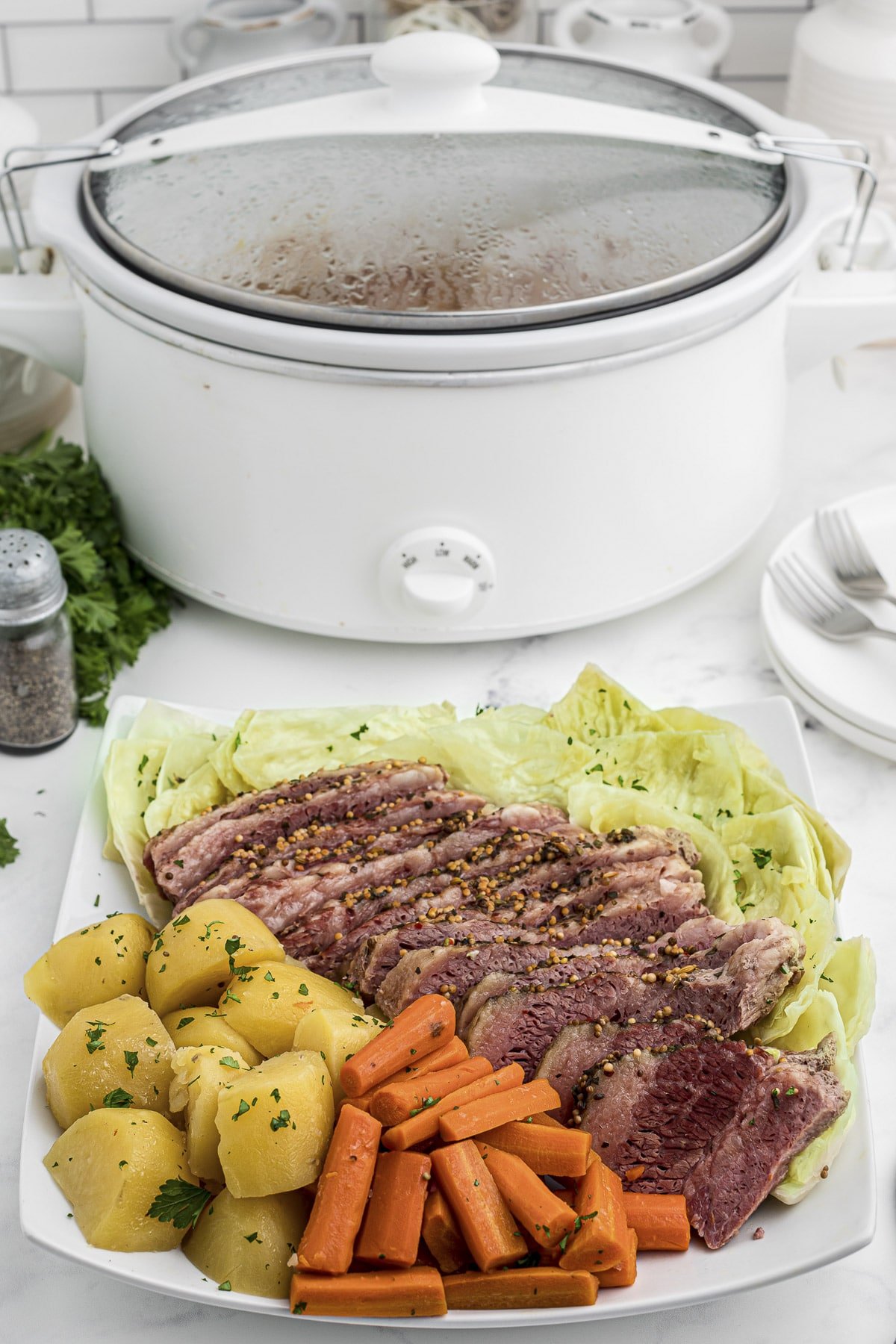 tray of corned beef and cabbage in front of slow cooker