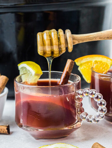 honey being drizzled on cranberry tea