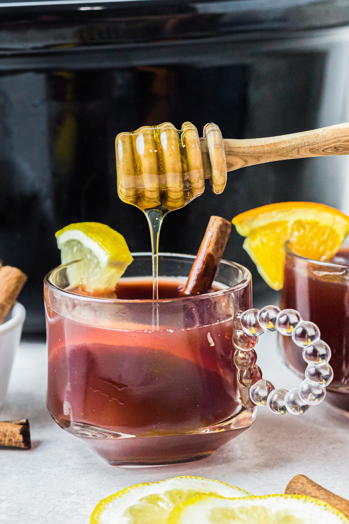 honey being drizzled on cranberry tea