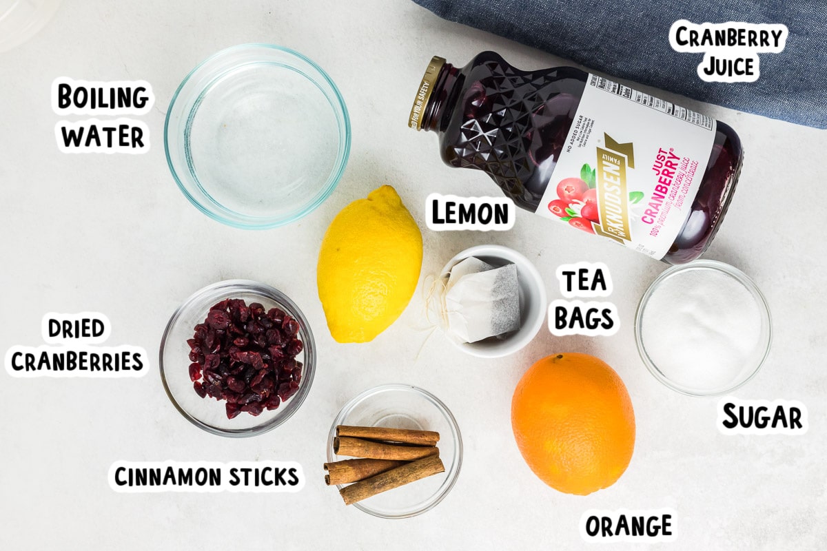 ingredients for crockpot tea on white table with text labels