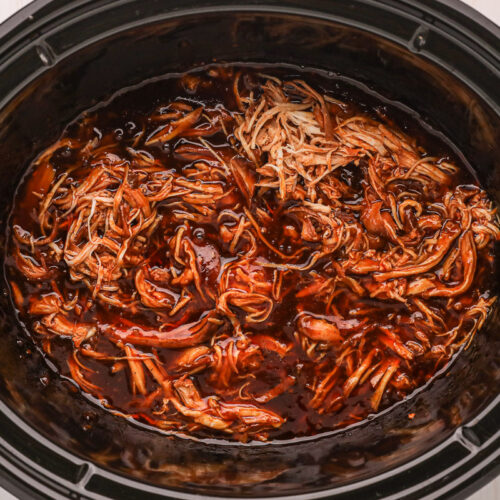 close up of shredded chicken in slow cooker