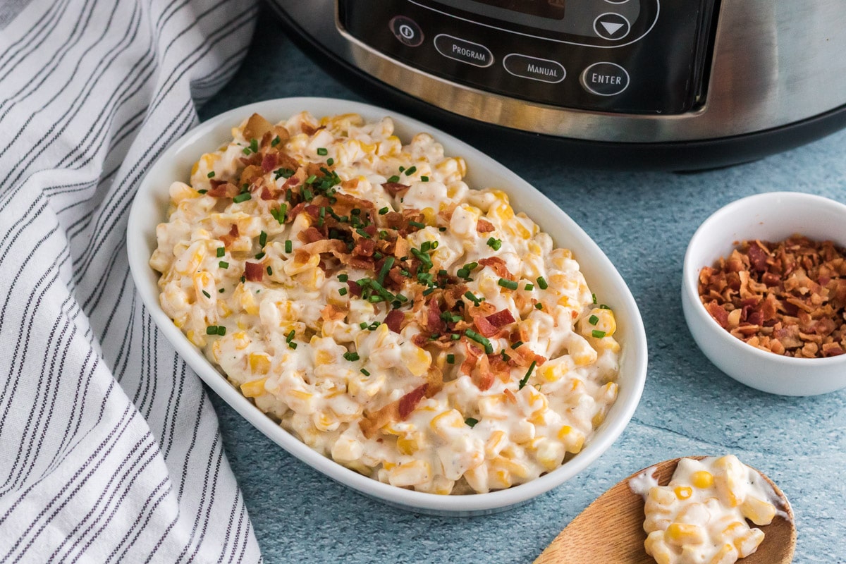 creamed corn in a white casserole dish