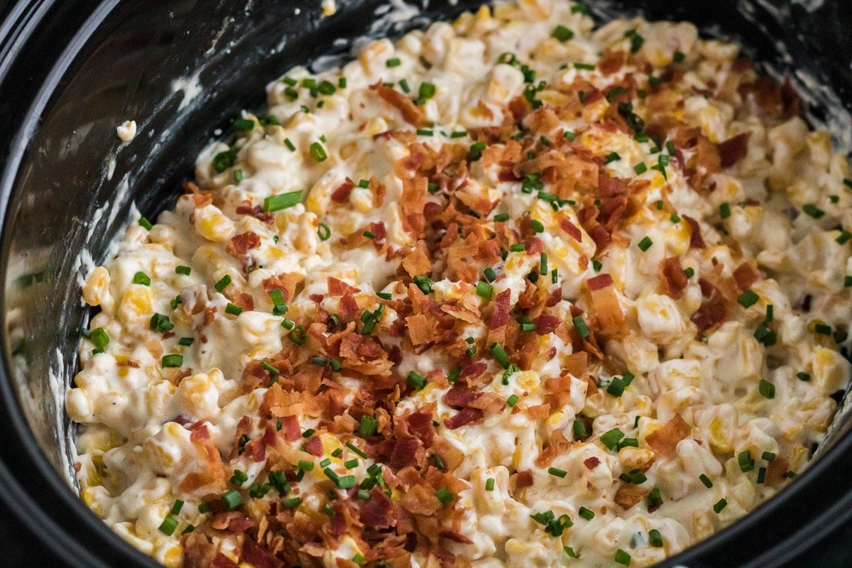 cooked creamed corn with bacon on top.