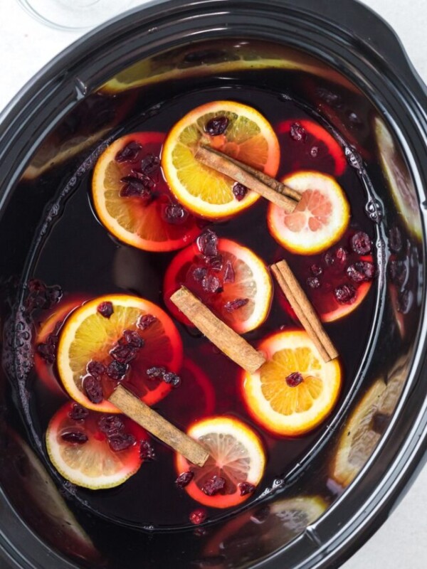 cranberry tea in the slow cooker with cinnamon sticks and oranges.