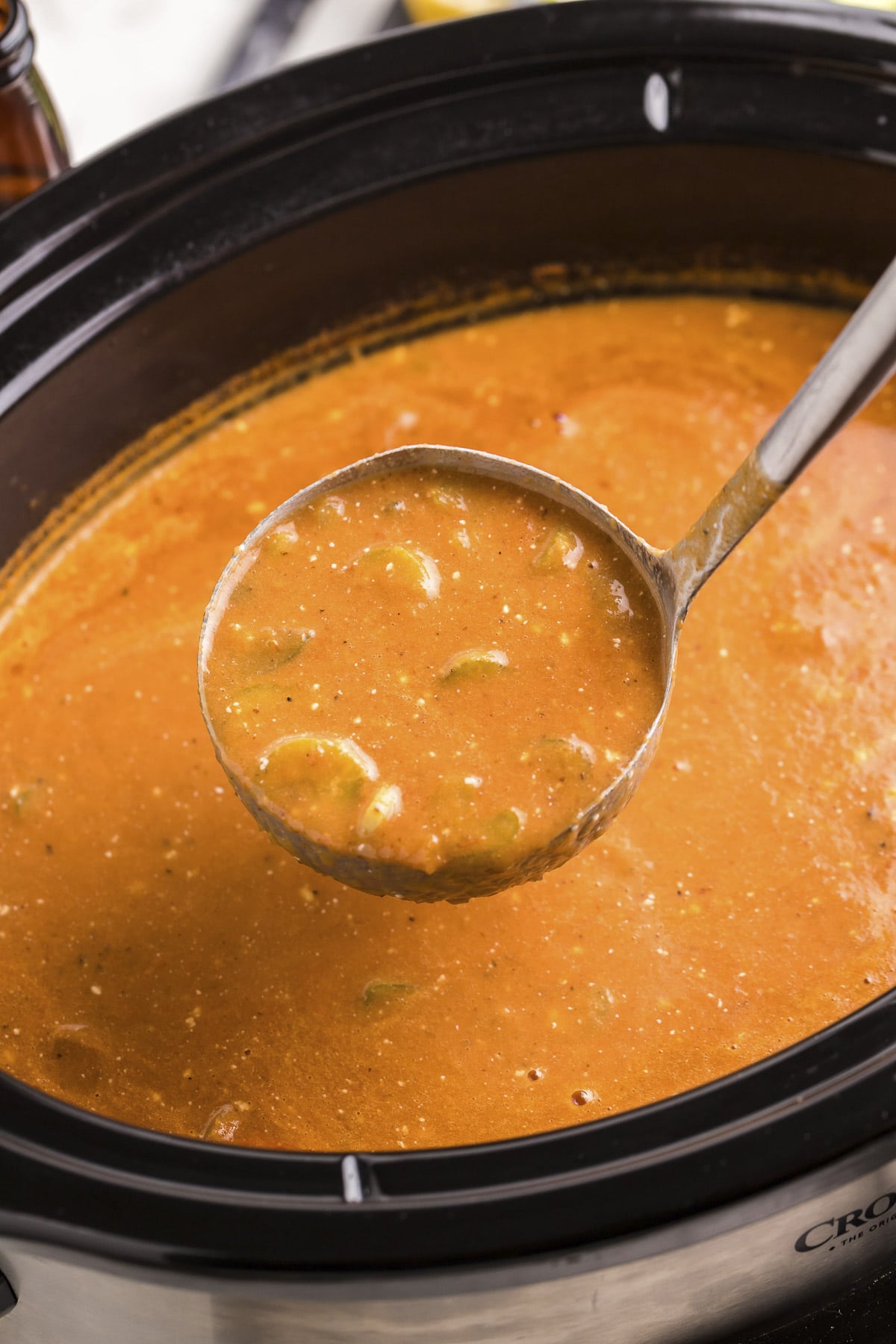 close up of bloody mary soup on ladle