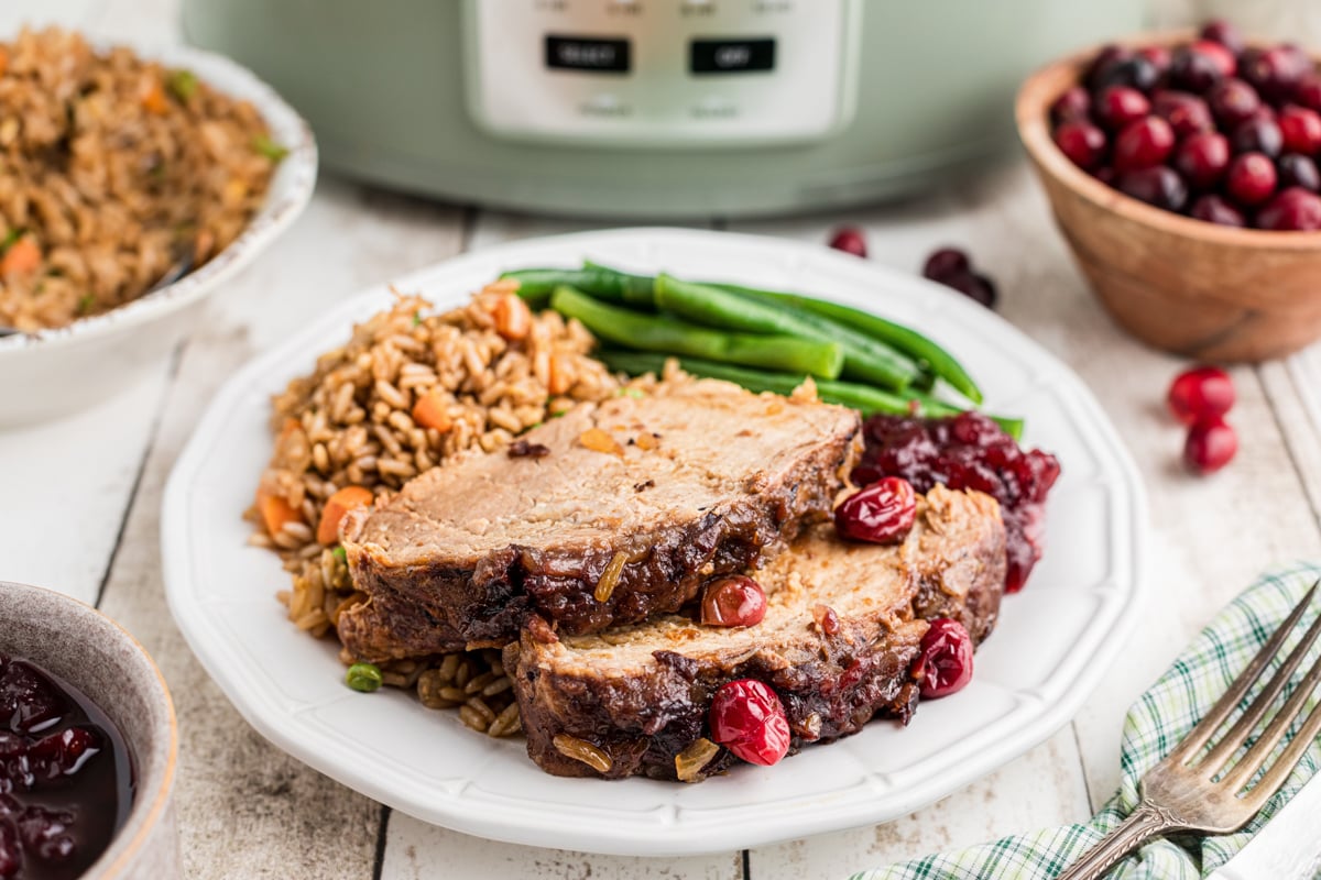 Plate of sliced cranberry pork loin with all the fixings.