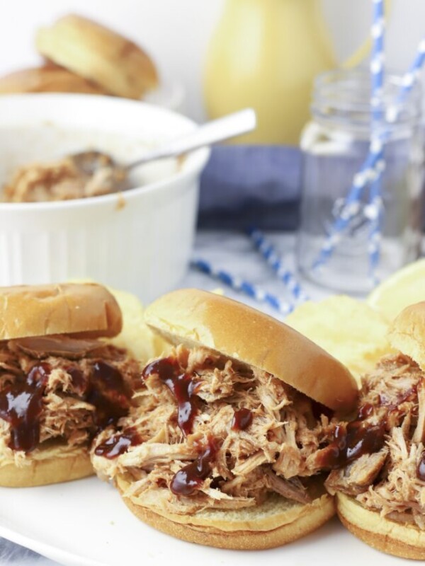 Bbq pork sandwiches with chips.