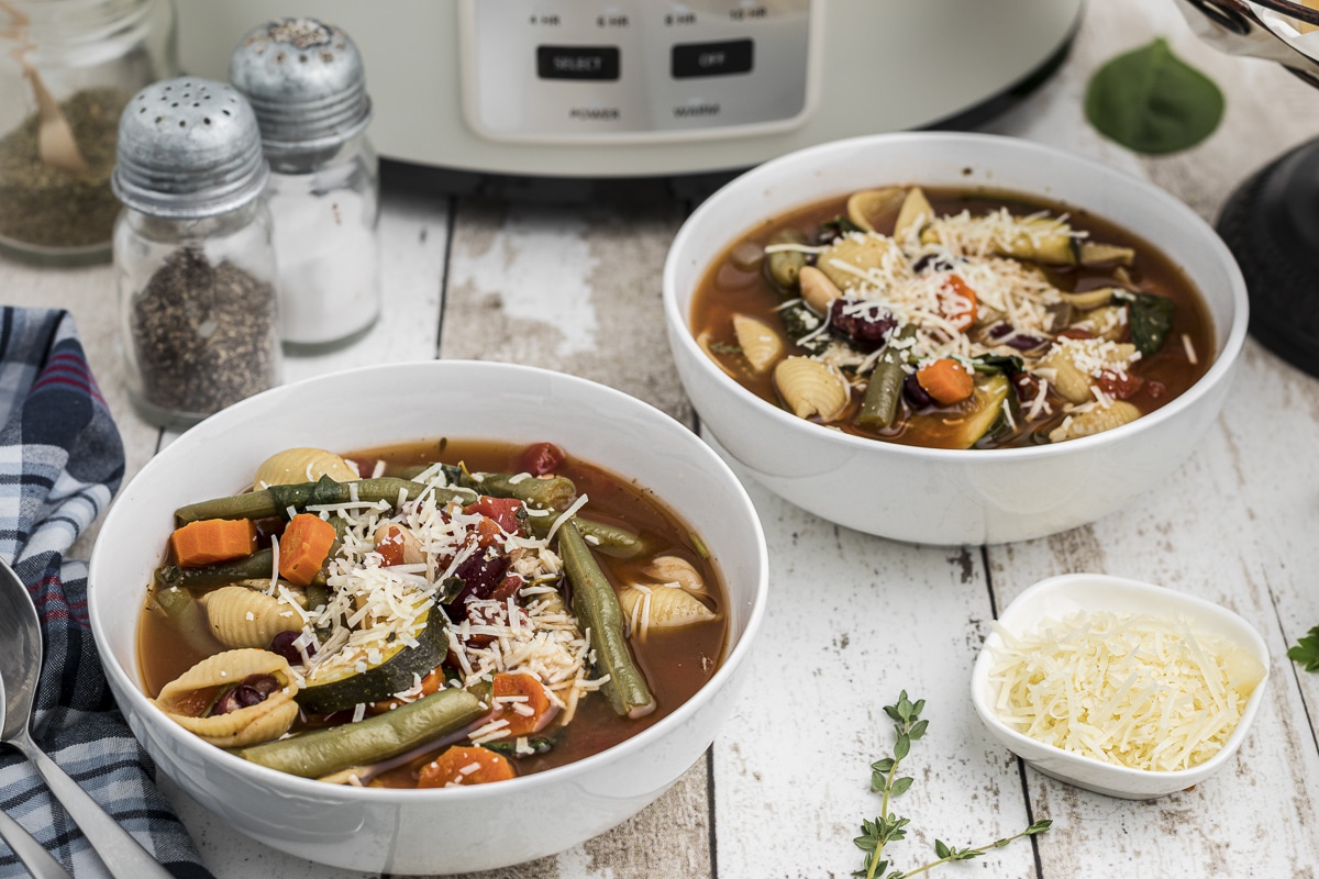 2 bowls of minestrone in front of slow cooker