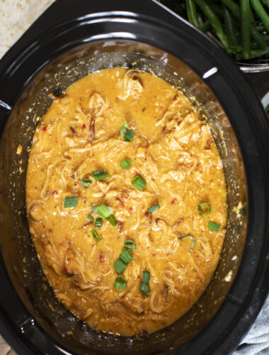 close up of shredded sweet chili chicken in crockpot