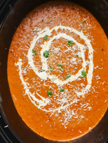 tomato soup in slow cooker with cream drizzle