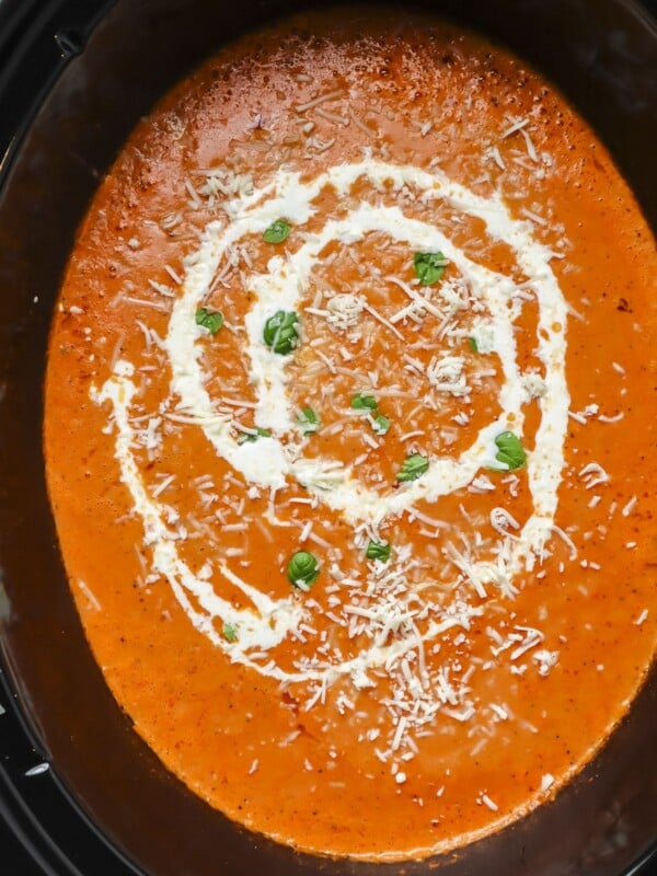 tomato soup in slow cooker with cream drizzle