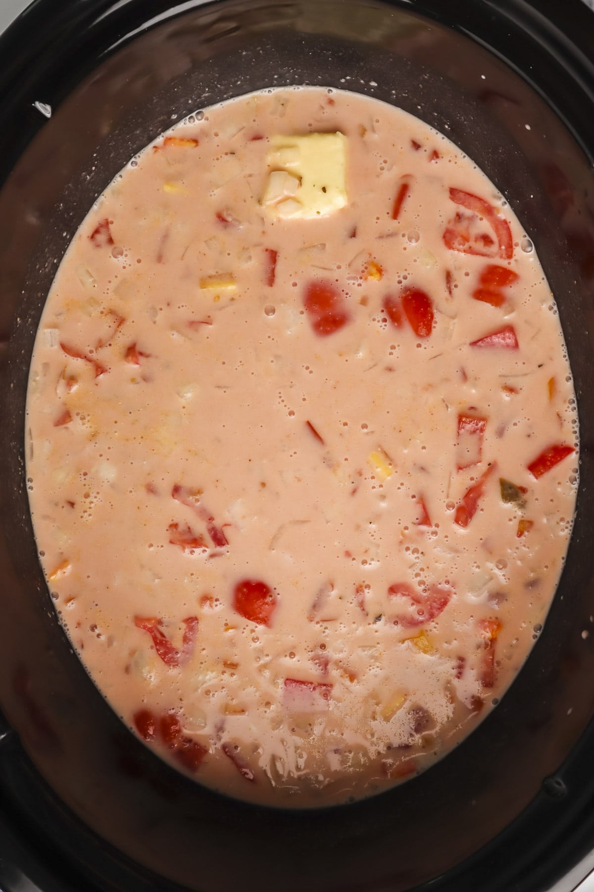 tomatoes, broth, cream and butter in a slow cooker.