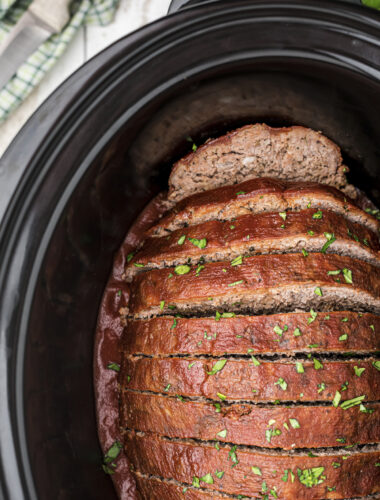 close up of venison meatloaf in slow cooker with glaze and parsley