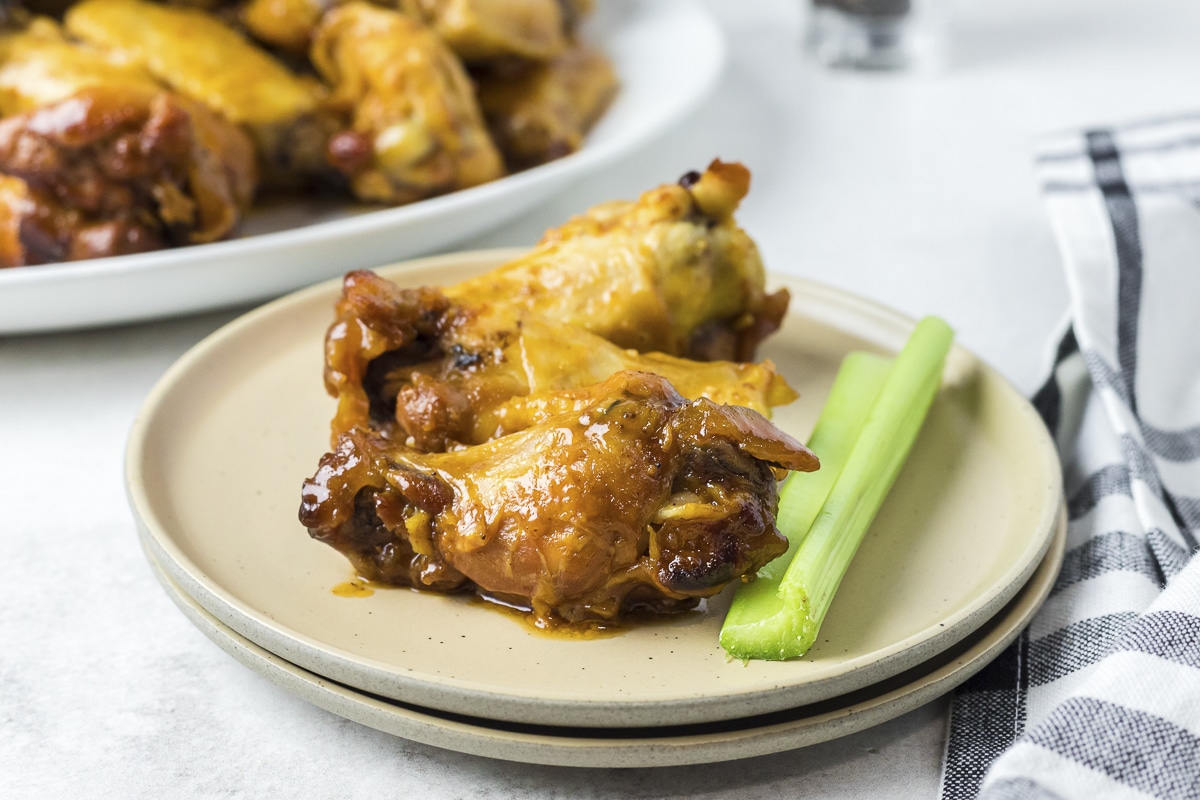 2 honey mustard wings on a plate