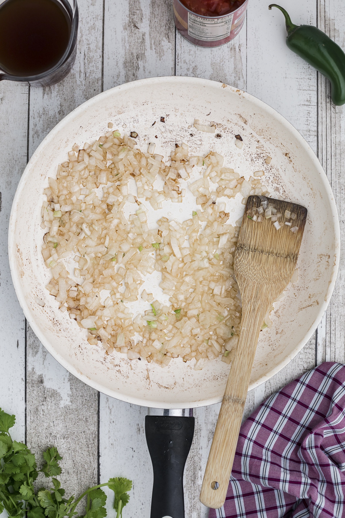 Onions being sauted in a skillet.
