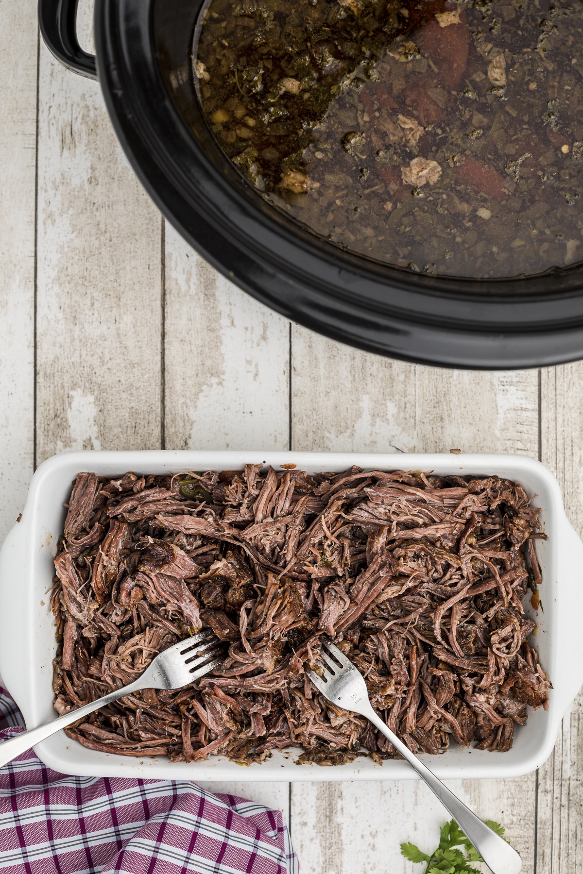 Beef being shredded on a plate.