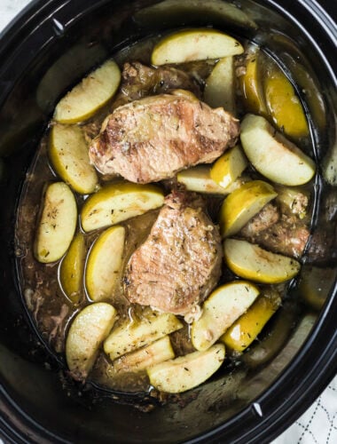 overhead shot of pork chops and apples in the slow cooker