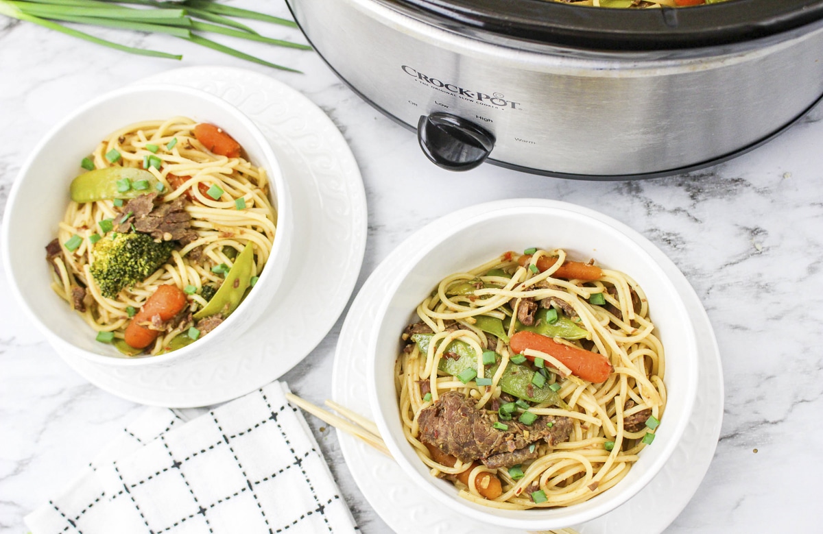 2 bowls of beef chow mein in front of slow cooker