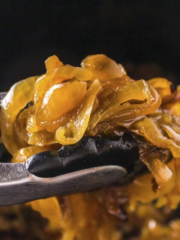 caramelized onions with tongs.