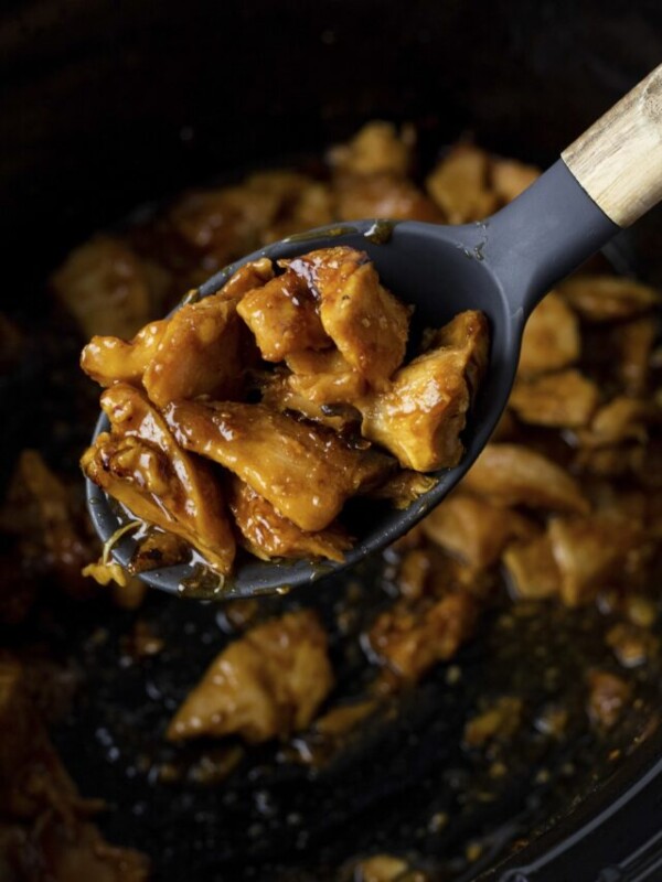 orange chicken on a spoon.