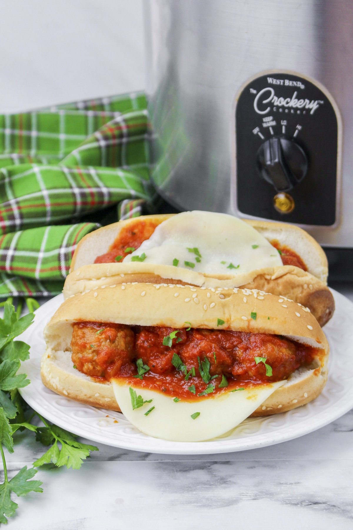meatballs subs in front of slow cooker.