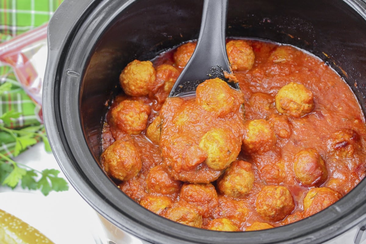 meatballs in marinara on a spoon.