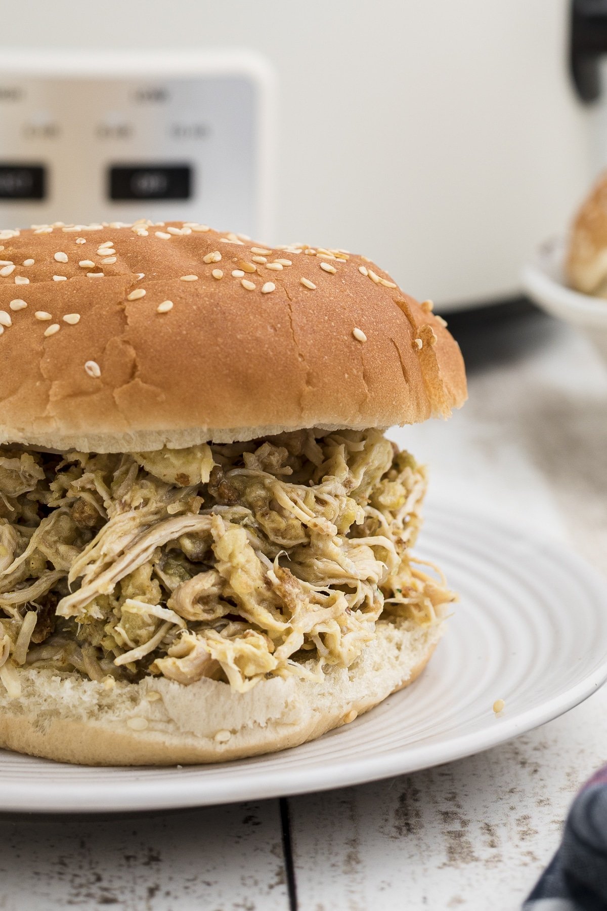 close up of ohio chicken sandwiches with slow cooker in background