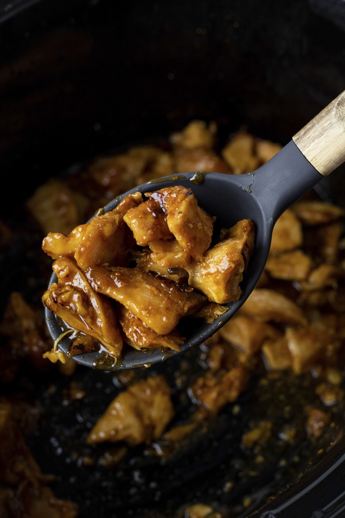 orange chicken on a spoon