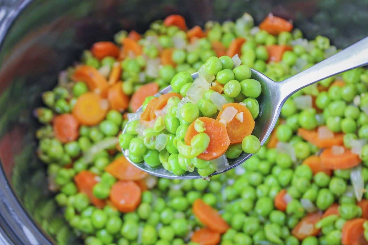 done cooking peas and carrots on a spoon