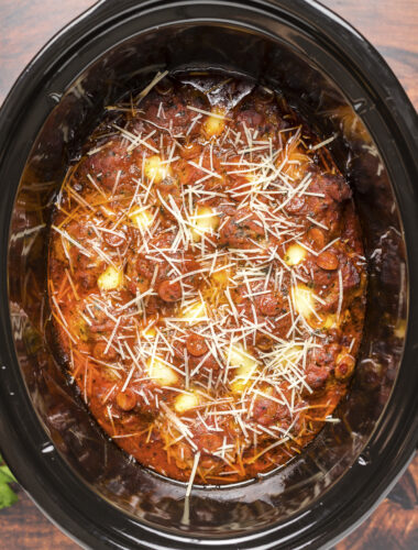 Over head shot of pizza meatballs with parmesan on top.