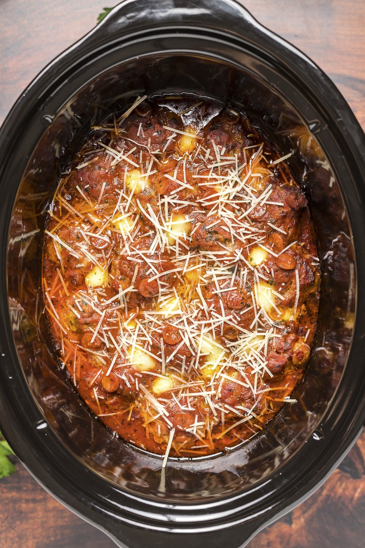 Over head shot of pizza meatballs with parmesan on top.