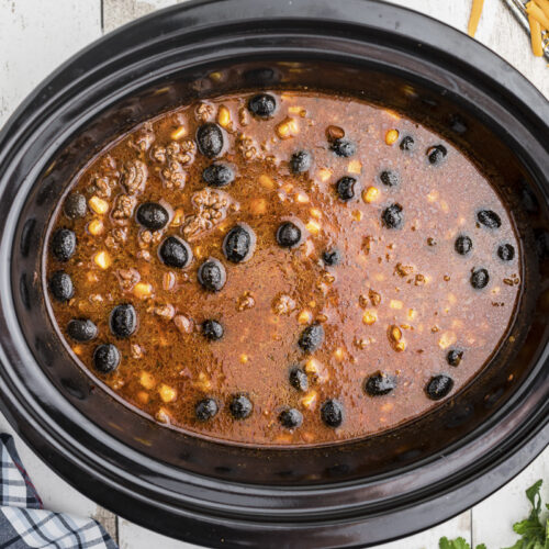 taco soup with corn, beef and olives in crockpot
