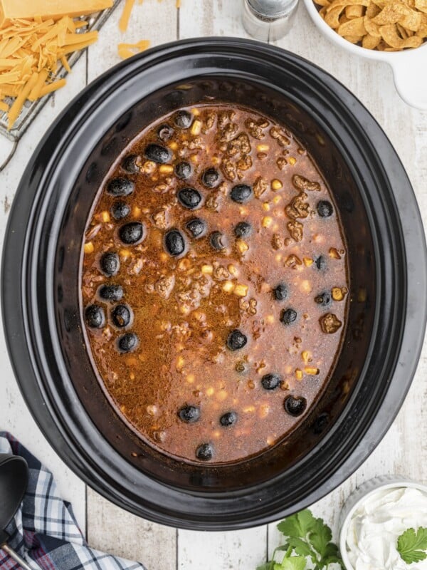 Taco soup in slow cooker with whole black olives