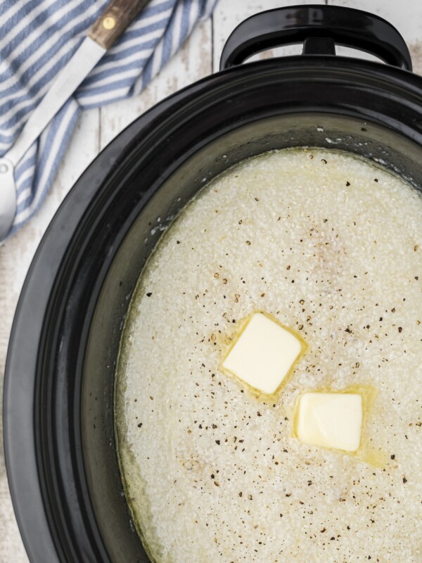 Grits cooked in a slow cooker with butter pats
