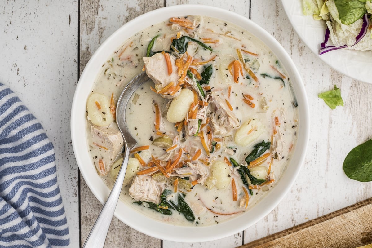 bowl of chicken gnocchi soup with spoon