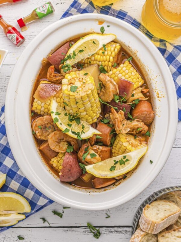shrimp boil in slow cooker with corn and parsley.