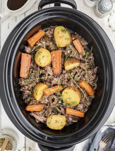 cooked venison pot roast in slow cooker.