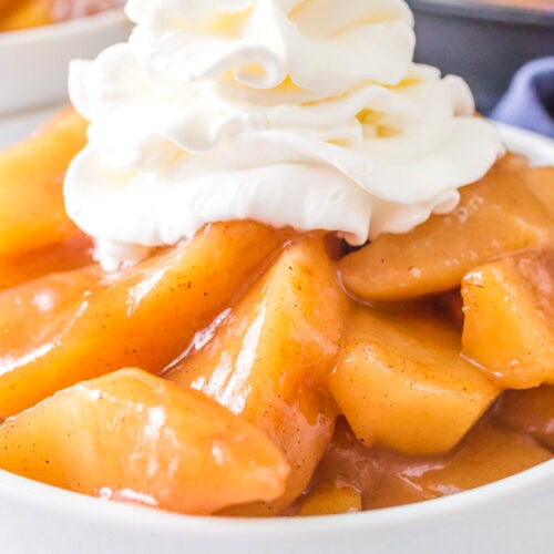 close up of fried apples with whipped cream