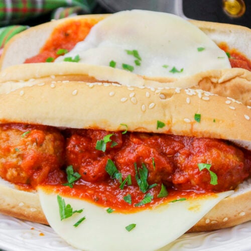 close up of meatball subs with cheese