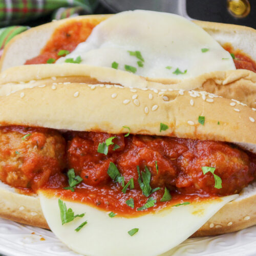 close up of meatball subs with cheese