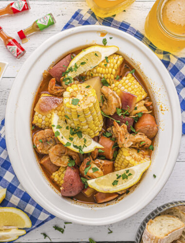 overhead shot of shrimp boil with corn and potatoes in slow cooker.