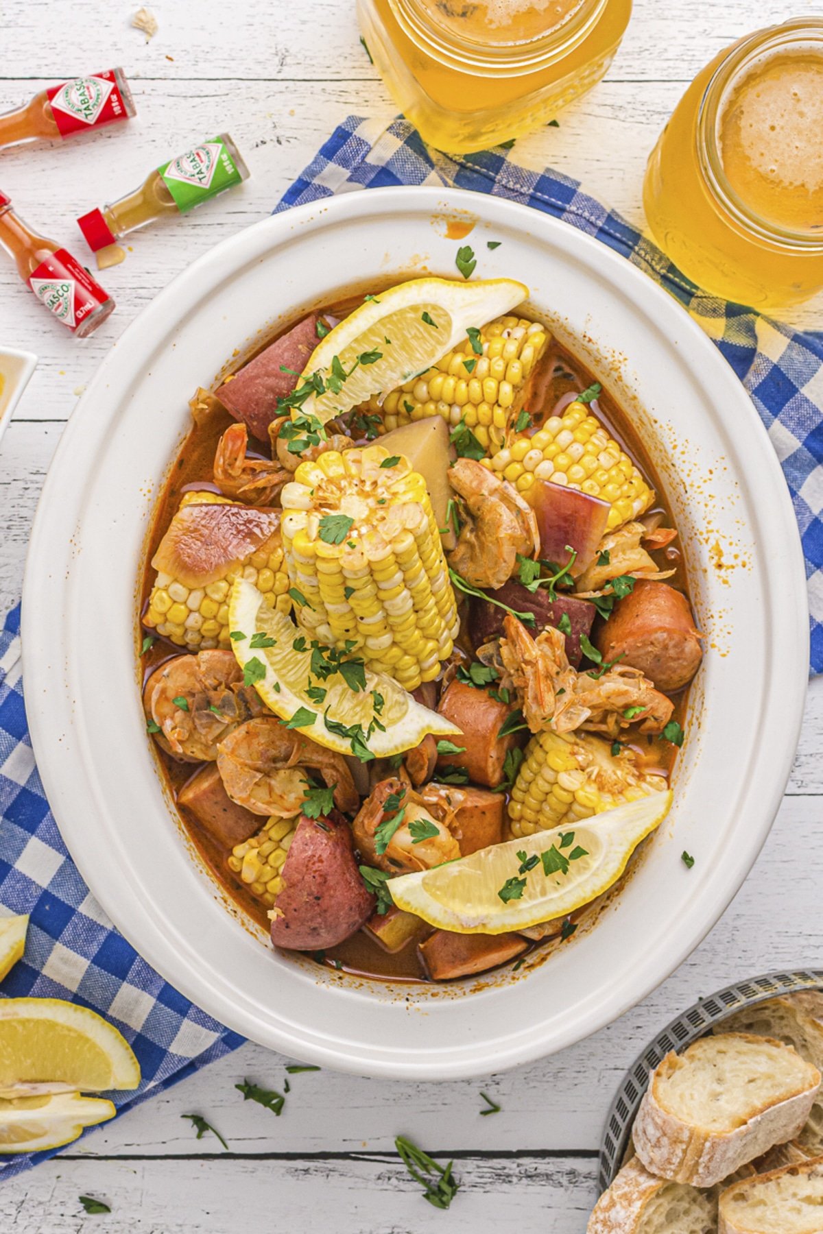 overhead shot of shrimp boil with corn and potatoes in slow cooker.